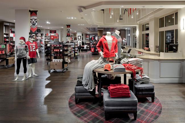College store interior shows a display of shirts and mannequins wearing  gear